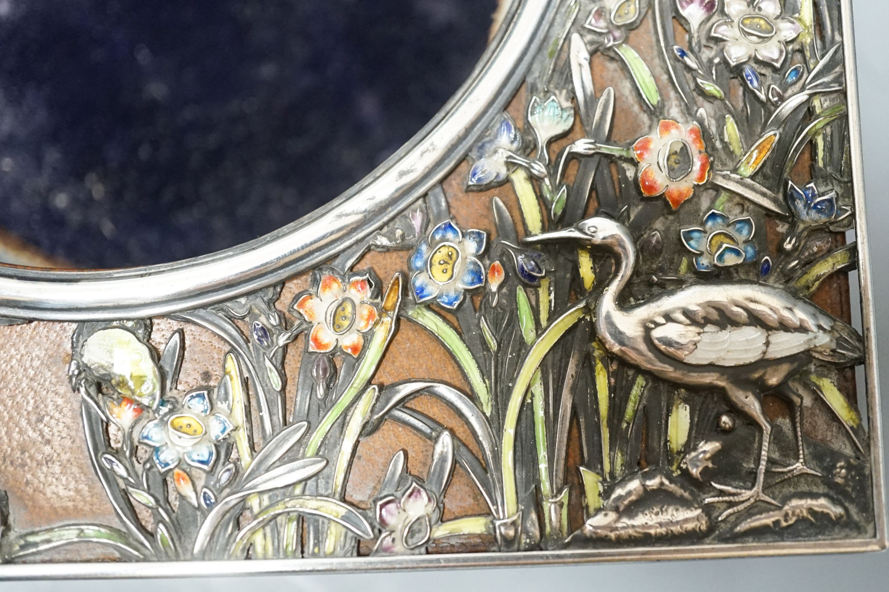 An early 20th century Japanese? white metal and polychrome enamel mounted leather travelling watch case, decorated with flowers and birds, 16.2cm.